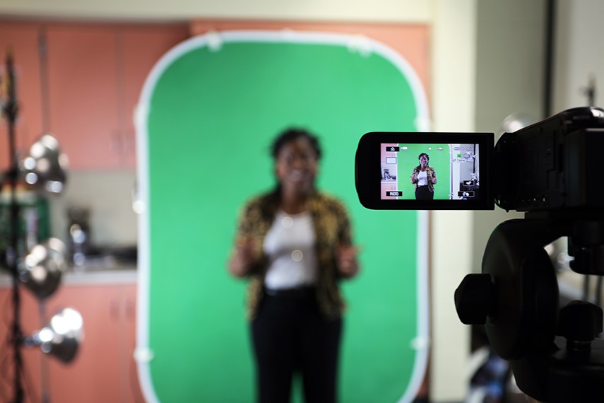 woman standing in front of green screen