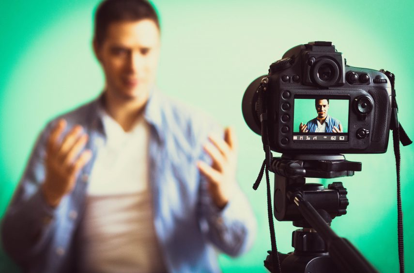 man sitting in front of video camera