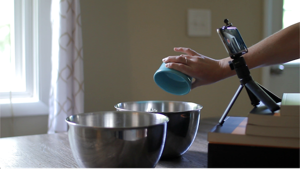 Person pouring ingredients into bowl