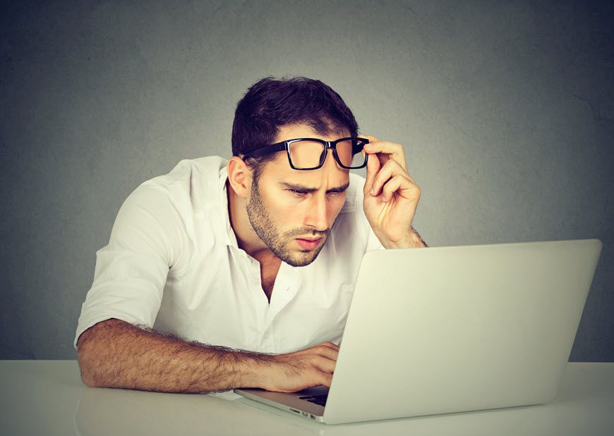 man with glasses at laptop