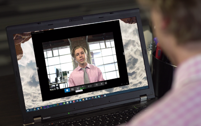 over-the-shoulder shot of professional man on webcam