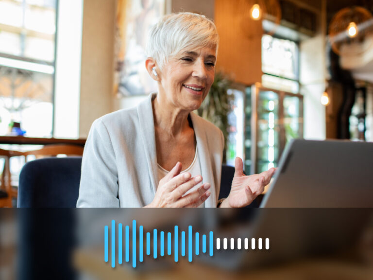 Someone speaking to a laptop with fuzzy audio waves turning into clear ones.